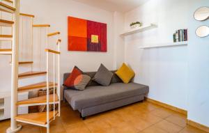 a living room with a couch with pillows on it at Cozy Apartment In Torrox Costa in Torrox Costa