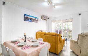 a dining room with a table and two yellow chairs at Apartamento Centro De Málaga in Málaga