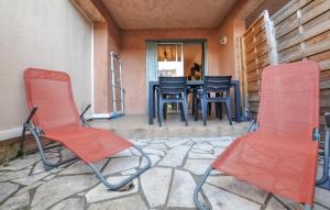 two chairs and a table on a patio at Nice Apartment In Fréjus With Wifi in Fréjus +8 photos
