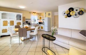 a living room and kitchen with a couch and a table at 2 Bedroom Amazing Home In Chassiers in Chassiers