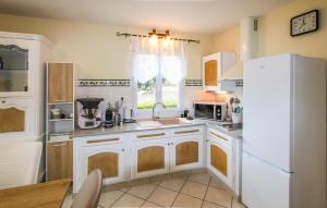 a kitchen with a white refrigerator and a sink at 2 Bedroom Amazing Home In Chassiers in Chassiers