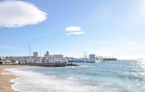 a view of a beach with a city and the ocean at Lovely Apartment In Fréjus With Wifi in Fréjus +8 photos