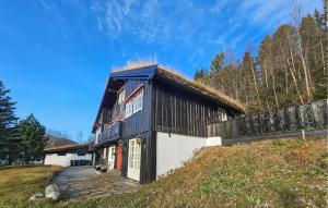 a building with a grass roof on a hill at 4 Bedroom Beautiful Home In Hemsedal in Hemsedal +10 photos