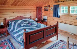 a bedroom with a bed in a log cabin at Lovely Home In Ustaoset With Wifi in Ustaoset
