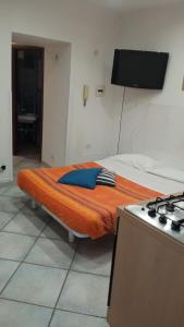 a bed in a room next to a stove at StabiaSummer in Castellammare di Stabia