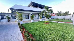 a house with a green yard in front of it at Luxury Home by Miami Int Airport in Miami
