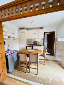 a kitchen with a wooden table and chairs at Lukare Apartman 1 in Novi Pazar