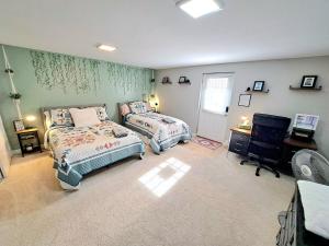 a bedroom with two beds and a desk and a desk at Quiet Retreat for Business or Family Trip in Charlotte