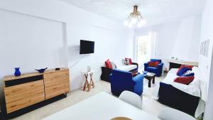 a living room with a bed and a couch at Gentle Breeze apartment in Kamena Vourla