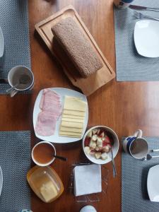 a table with two plates of food with cheese and meat at Hostal Nahuel Ray in Pucón