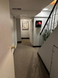 a hallway with a stairway leading to a room with a painting at Your Home away from Home ! in Baychester +2 photos