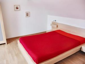 a red bed in a white room at Maison de Campagne Familiale à Portbail - 6 personnes in Portbail