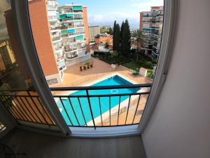 a view of a swimming pool from a window in a building at Frida&Love in Torremolinos