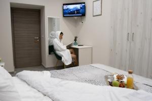 TV a/nebo společenská místnost v ubytování Le Mirage boutique II