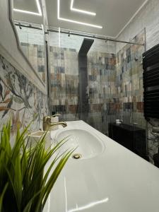 a bathroom with a white sink and a mirror at APARTAMENT - Torino Home Living in Turin +10 photos