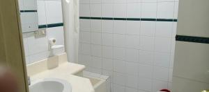 a white bathroom with a toilet and a shower at HOTEL BOMBUSCARo in Loja +11 photos