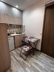 a small kitchen with a table and two chairs at Small budjet deluxe studio down town in Thessaloniki