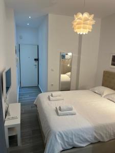 a bedroom with two beds and a large mirror at Small budjet deluxe studio down town in Thessaloniki