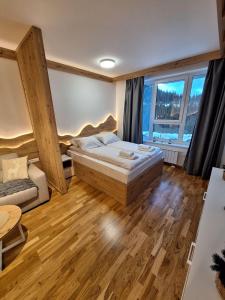 a bedroom with a bed and a large window at Apartman Vučko Dalia - Aparthotel Vučko in Jahorina