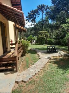 a park with a bench and a picnic table at Pousada Dona Elza in Monte Verde