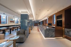 a restaurant with a bar with chairs and tables at Beijing Tiananmen Wangfujing Ruibeting Apartment Hotel in Beijing