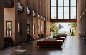 a lobby of a resort with tables and chairs at The Cove at Atlantis in Nassau