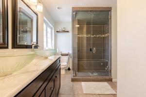 a bathroom with a glass shower and a sink at Mountain View-Steam Shower-2 Tier Patio- King Bed in Northampton +50 photos