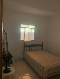 una camera da letto con un letto e una finestra di Casa Para Veraneio em Ilhéus - Zona Sul a Ilhéus