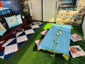 a porch with a table on the grass at HiGhLanDer SeAsuN in San Fernando