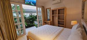 Ένα ή περισσότερα κρεβάτια σε δωμάτιο στο Central Canggu Guesthouse