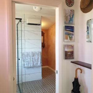 a shower with a glass door in a bathroom at Huon Belle Homestead in Waterloo