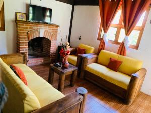 a living room with two couches and a fireplace at Cabañas los cactus 2 in Huasca de Ocampo