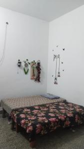 a bedroom with a bed with a bedspread and decorations at Prayag Homestays ADA in Prayagraj