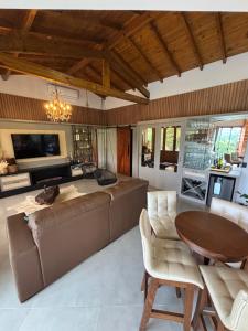 a living room with a couch and a table at Refúgio nascer das águas in Gravatal