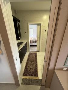 a hallway leading to a kitchen with a bed at Refúgio nascer das águas in Gravatal