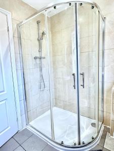a shower with a glass enclosure in a bathroom at Your next room in Portsmouth in Portsmouth