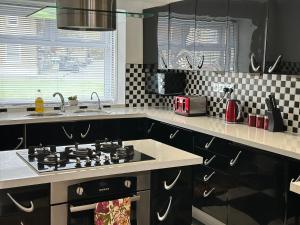 a kitchen with a stove and a sink at Your next room in Portsmouth in Portsmouth +13 photos