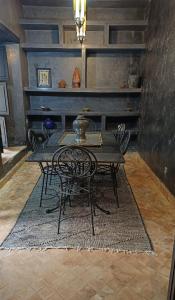 a dining room with a table and chairs on a rug at Riad Palais Bahia - Entire House - 5 Bedrooms in Marrakech