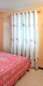 a room with a bed and a curtain with flowers at Charming villa in Flic en Flac with private pool in Flic-en-Flac +21 photos