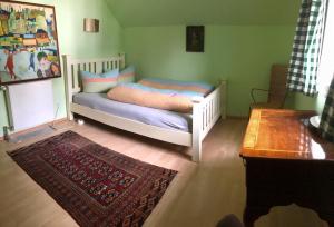 a bedroom with a bed with a rug and a table at Alpenchalet in Murnau am Staffelsee