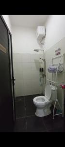 a small bathroom with a toilet and a shower at Sukabumi Villa Mochi Private Mini Pool in Sukabumi