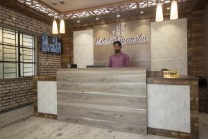 a man standing behind a counter in a room at Super Capital O Priyanshu in Siliguri +55 photos