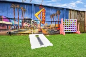 a building with a painting on it with a ping pong table at Vibrant Vegas Vibes - Hot Tub & Games - Perfect 4 Family & Groups in Houston