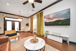a living room with a couch and a table at Vibrant Vegas Vibes - Hot Tub & Games - Perfect 4 Family & Groups in Houston