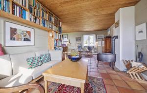 a living room with a couch and a table at 4 Bedroom Stunning Home In Karby in Karby