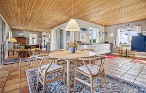 a kitchen and dining room with a table and chairs at 4 Bedroom Stunning Home In Karby in Karby