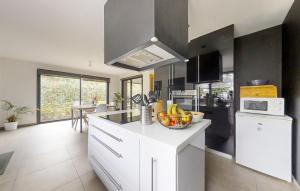 a kitchen with a counter with a bowl of fruit on it at 3 Bedroom Lovely Home In Fouesnant in Fouesnant