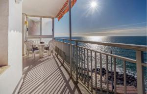 a balcony with a table and chairs and the ocean at Nice Apartment In Oropesa Del Mar in Oropesa del Mar
