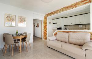 a living room and dining room with a couch and a table at Nice Apartment In Oropesa Del Mar in Oropesa del Mar