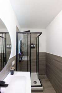 a bathroom with a shower and a sink at Urban Chic Luxury Suite Apartments in Rome